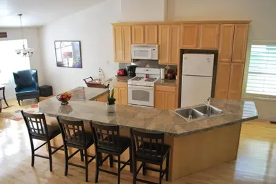a kitchen with a large island with a counter top at Big Tom's Cabin by Yosemite, lake and trails in Groveland
