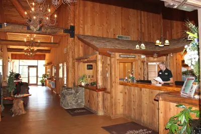 a man standing at a bar in a wooden building at The Pines Resort & Conference Center in Bass Lake
