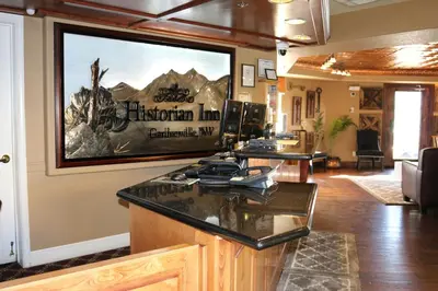 a living room with a large television on the wall at Historian Inn in Gardnerville