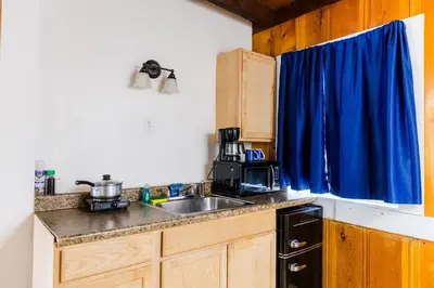 a kitchen with a sink and a blue curtain at The Washoe Lodge in South Lake Tahoe