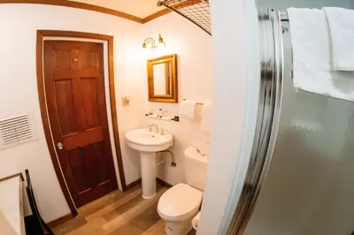 a bathroom with a toilet and a sink at Narrow Gauge Inn in Fish Camp