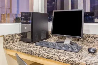 a computer monitor and keyboard on a counter at Days Inn by Wyndham Modesto in Modesto