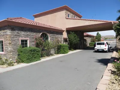 a car parked in front of a house at Death Valley Inn in Beatty
