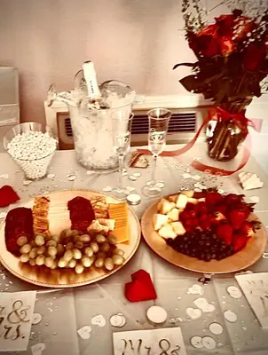 a table with two plates of food and wine glasses at Death Valley Inn in Beatty