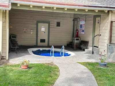 a patio with a swimming pool in the back of a house at La Vista Blanc #61 Condo in Mammoth Lakes