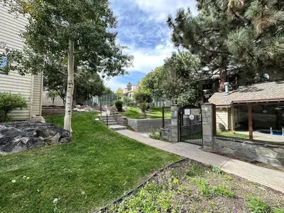 a house with a fence and a yard at La Vista Blanc #61 Condo in Mammoth Lakes