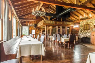 a dining room with tables and chairs and a chandelier at Sierra Sky Ranch in Oakhurst