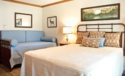 a bedroom with a bed and a blue couch at Sierra Sky Ranch in Oakhurst