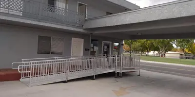 a building with a porch with a balcony at Mountain View Motel in Bishop