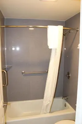a bathroom with a shower with a tub and a toilet at Trails Motel in Lone Pine
