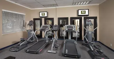a gym with a row of exercise bikes in a room at Lake Natoma Inn in Folsom