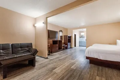 a hotel room with a bed and a couch at Country Inn Sonora in Sonora