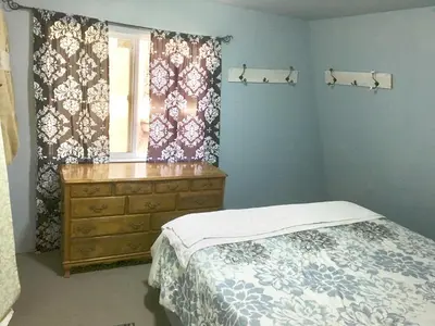 a bedroom with a bed and a dresser and a window at Sequoia National Forest CabinG in Panorama Heights
