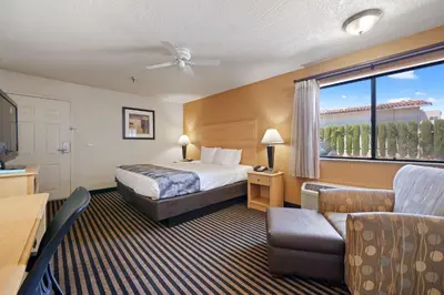 a hotel room with a bed and a couch at Best Western Plus Executive Inn & Suites in Manteca