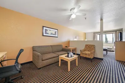 a living room with a couch and a chair at Best Western Plus Executive Inn & Suites in Manteca