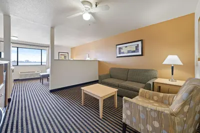 a living room with a couch and a table at Best Western Plus Executive Inn & Suites in Manteca