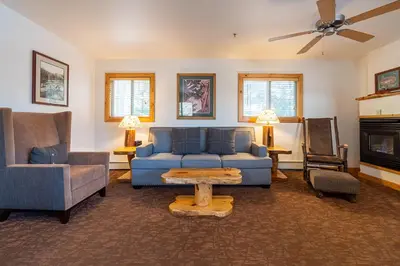 a living room with a blue couch and chairs at Red Wolf Lakeside Lodge in Tahoe Vista