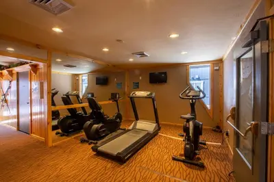 a gym with several tread machines in a room at Red Wolf Lodge at Olympic Valley in Olympic Valley