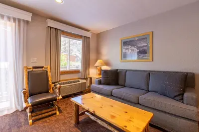 a living room with a couch and a table at Red Wolf Lodge at Olympic Valley in Olympic Valley