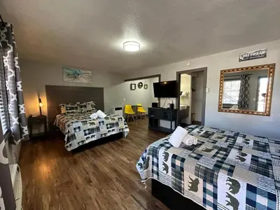 a hotel room with two beds and a television at Lake Ridge South Lake Tahoe in South Lake Tahoe