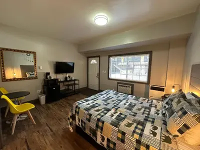 a bedroom with a bed and a table and a television at Lake Ridge South Lake Tahoe in South Lake Tahoe