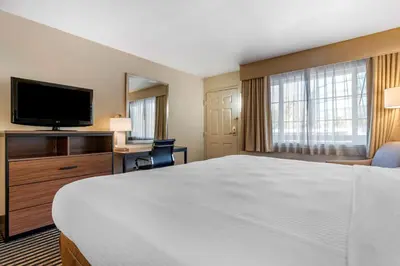 a hotel room with a bed and a flat screen tv at Best Western Town House Lodge in Modesto