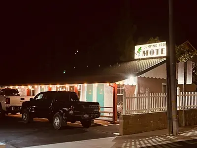 a truck parked in front of a house at night at Jumping Frog Motel in Angels Camp