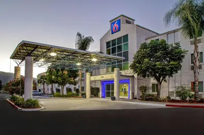 a building with a sign on top of it at Motel 6-Gilroy, CA in Gilroy