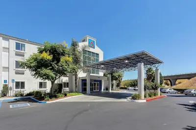 a building with a parking lot in front of it at Motel 6-Gilroy, CA in Gilroy