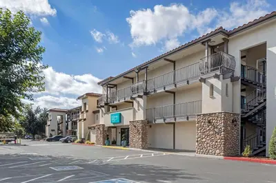 an empty parking lot in front of a hotel at Hillstone Inn Tulare, an Ascend Collection Hotel in Tulare