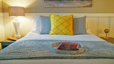 a bed with a tray with a book on it at Playpark Lodge in South Lake Tahoe