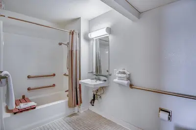 a bathroom with a sink and a shower at Super 8 by Wyndham Tracy in Tracy