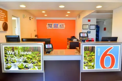 a waiting area of a hospital with two signs at Motel 6 - Santa Nella, on i-5 in Santa Nella Village
