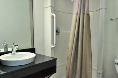a bathroom with a sink and a shower at Motel 6 - Santa Nella, on i-5 in Santa Nella Village