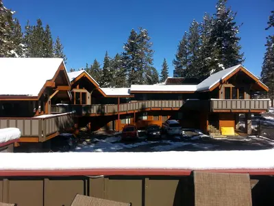 a house in the winter with snow on the roof at Gondola Lodge & Tahoe Beach Club in South Lake Tahoe