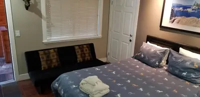 a bedroom with a bed and a chair in it at Gondola Lodge & Tahoe Beach Club in South Lake Tahoe