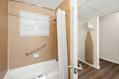 a bathroom with a bath tub and a window at Best Western Stagecoach Inn in Pollock Pines