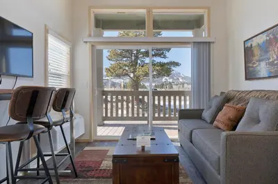 a living room with a couch and a table at Sierra Meadows Ranch in Mammoth Lakes