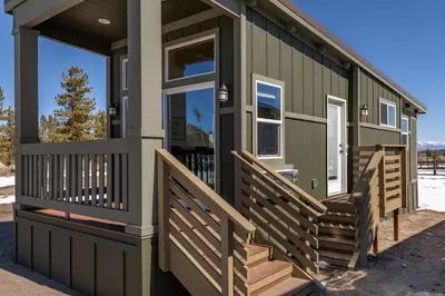 a green house with wooden stairs on a house at Sierra Meadows Ranch in Mammoth Lakes