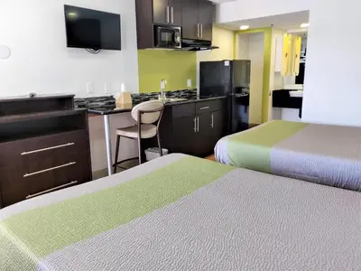 a hotel room with two beds and a kitchen at Studio 6-Fresno, CA - Extended Stay in Pinedale