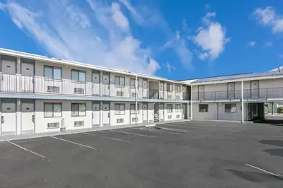 an empty parking lot in front of a building at Super 8 by Wyndham Bishop in Bishop