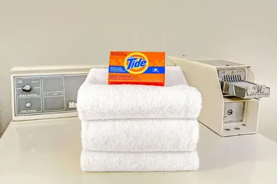 a stack of towels with a box on top of them at Days Inn by Wyndham Carson City in Carson City