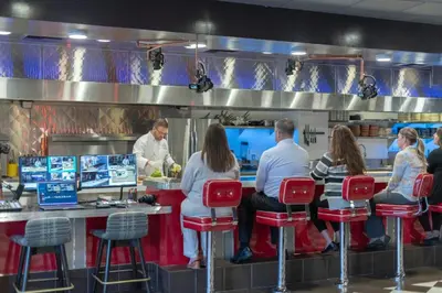 a group of people sitting at a counter in a restaurant at Renaissance Reno Downtown Hotel & Spa in Reno