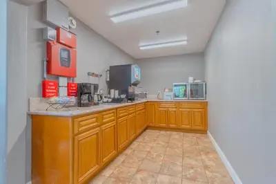 a large kitchen with wooden cabinets and a counter at The Monarch Inn in Mariposa