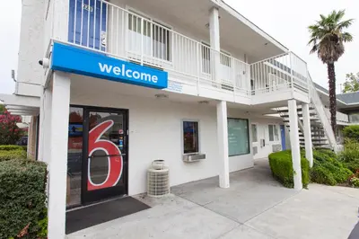 a building with a welcome sign in front of it at Motel 6-Sacramento, CA - Central in Sacramento