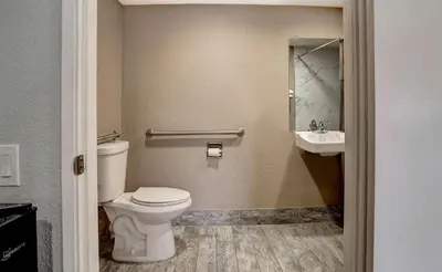 a bathroom with a toilet and a sink at Motel 6-Rancho Cordova, CA - Rancho Cordova East in Rancho Cordova