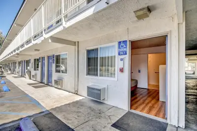 an empty building with a door and a balcony at Motel 6-Stockton, CA - North in Lincoln Village