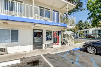 a car parked in front of a store at Motel 6-Stockton, CA - North in Lincoln Village