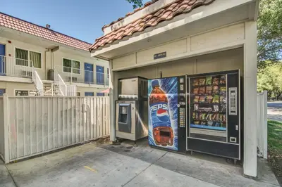 a building with a soda machine in front of it at Motel 6-Stockton, CA - North in Lincoln Village