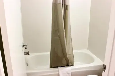 a bathroom with a shower curtain next to a bath tub at Motel 6-Coalinga, CA - East in Coalinga